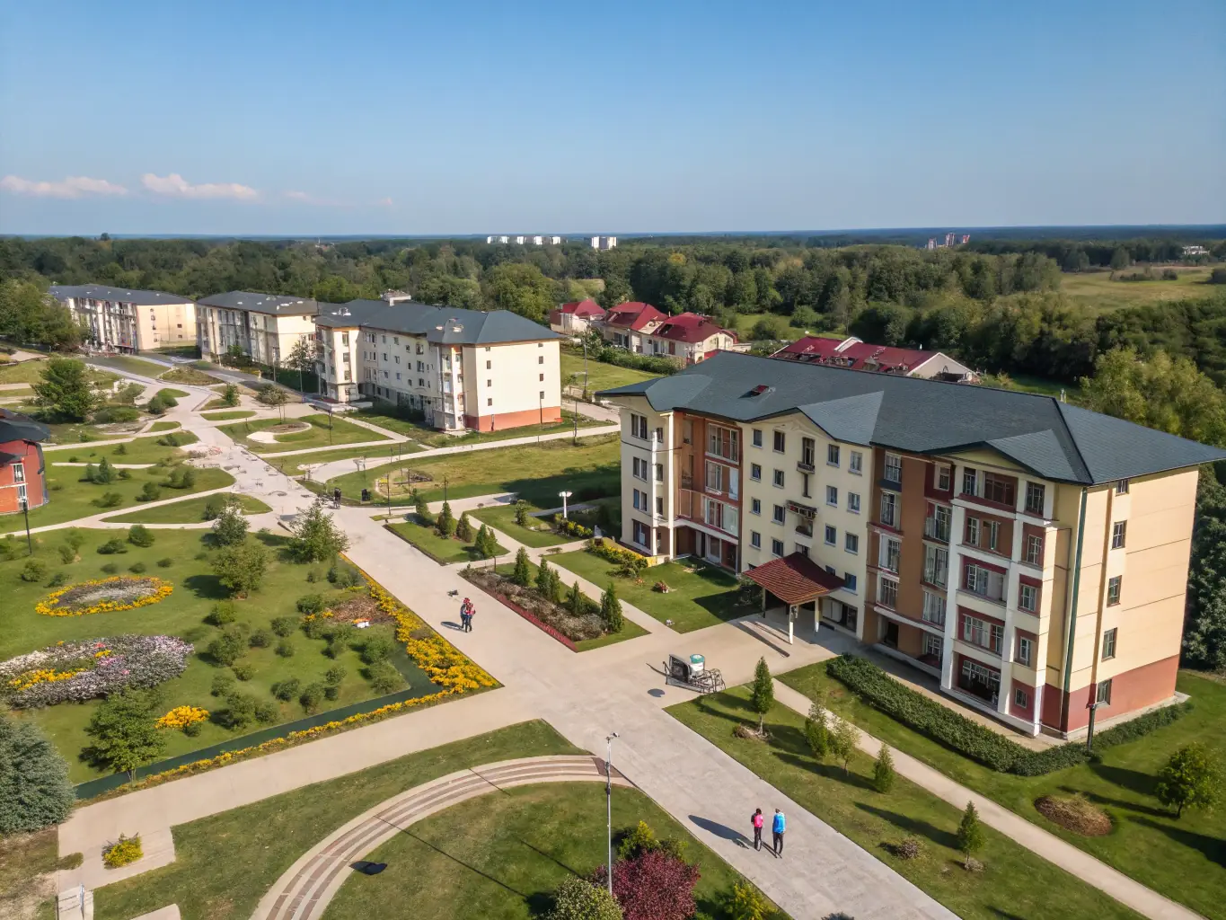 An aerial view of an integrated township, showcasing a mix of commercial, residential, and recreational spaces, highlighting the self-sufficient and community-focused environment.